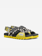 Black and yellow sandals with zebra pattern on a white background