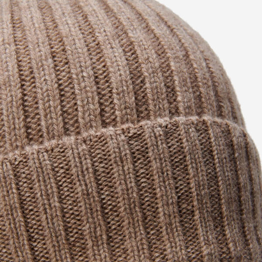 Close-up of a brown knitted beanie with ribbed texture.