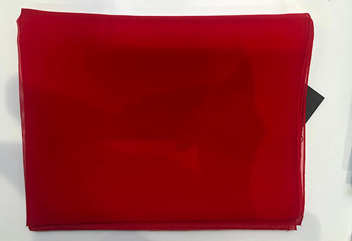 Red fabric with a black tag on a white background