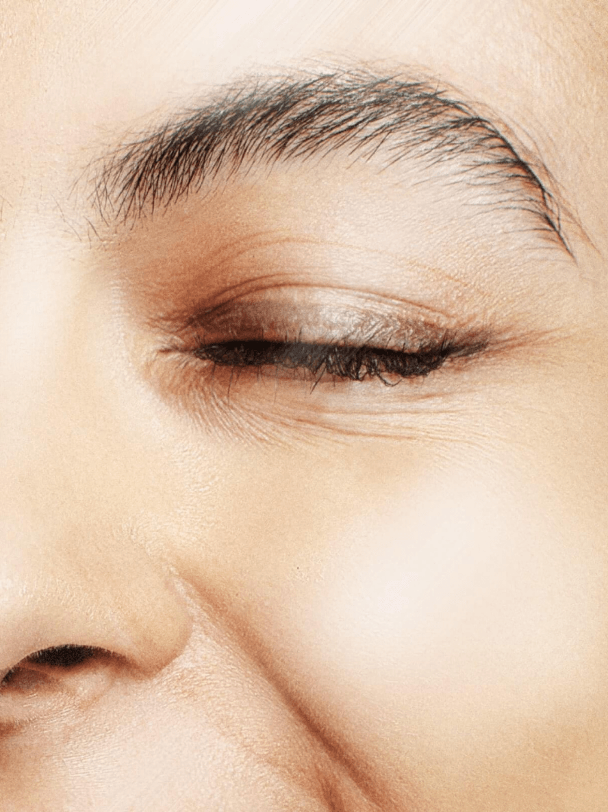 Close-up of an elderly woman's eye with visible wrinkles.