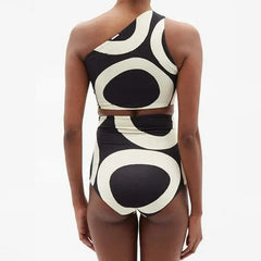 Black and white patterned swimsuit on a plain background