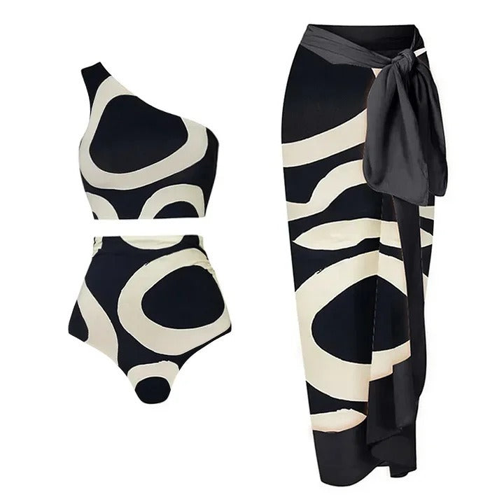 Black and white patterned swimsuit with matching sarong on a white background