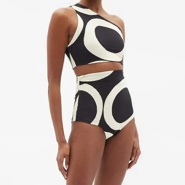 Black and white patterned swimsuit on a model against a white background