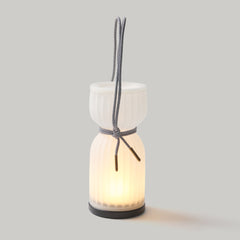 Ceramic lantern with a light inside on a gray background