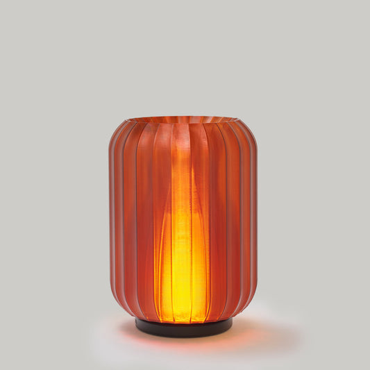 Decorative lamp with ribbed design on a plain background