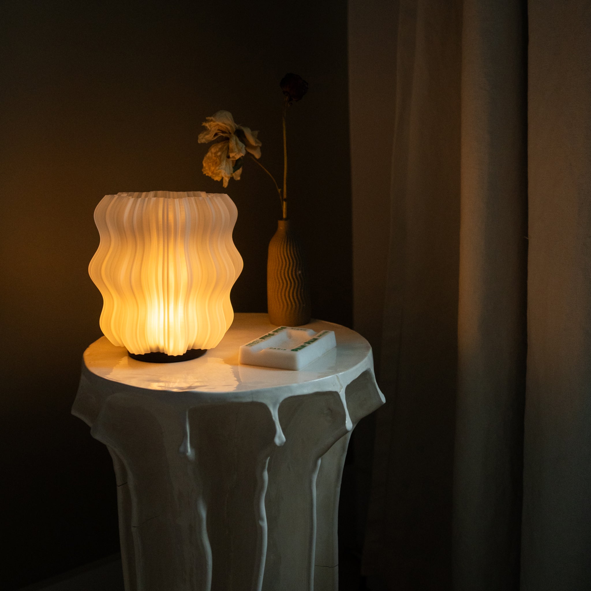 Decorative lamp on a small table with a dark background