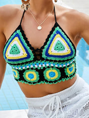 Colorful crochet top with geometric patterns against a blurred background