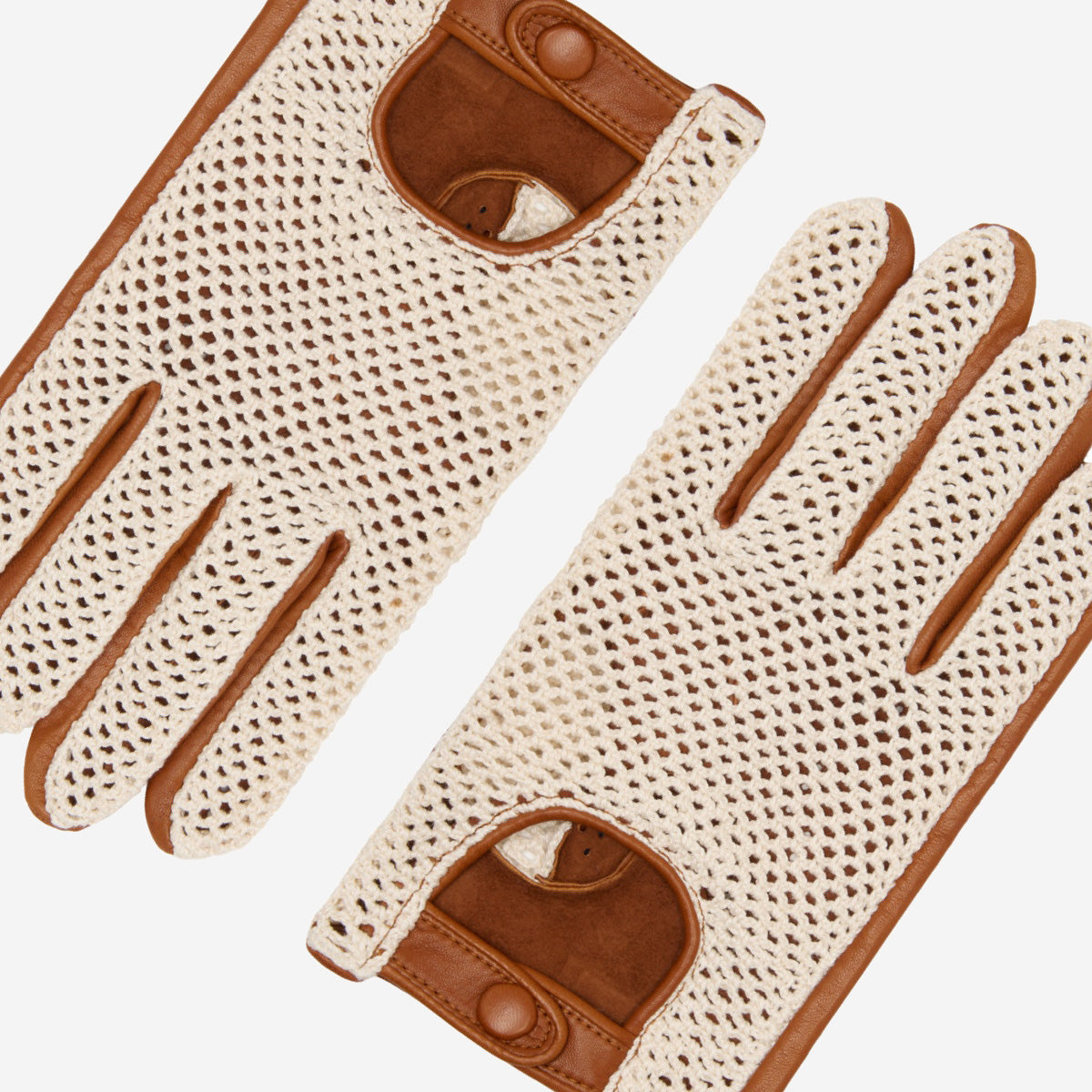 Pair of beige driving gloves with brown leather accents on a white background