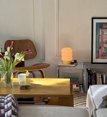 Living room with a wooden table, chair, and decorative items.