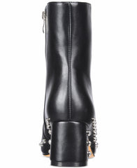 Black leather boot with decorative elements on a white background