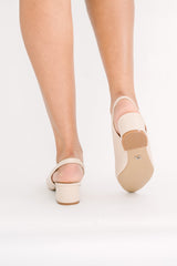 Ballet shoes worn by a person on a white background