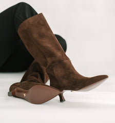 Brown suede knee-high boots on a white background
