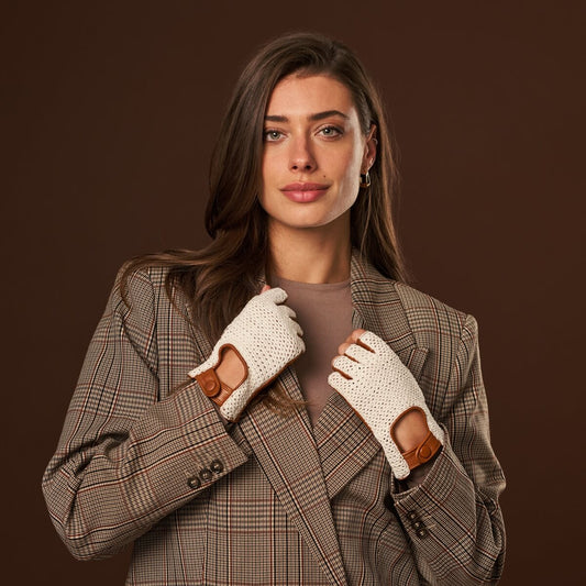 Woman wearing a plaid coat and white gloves against a brown background