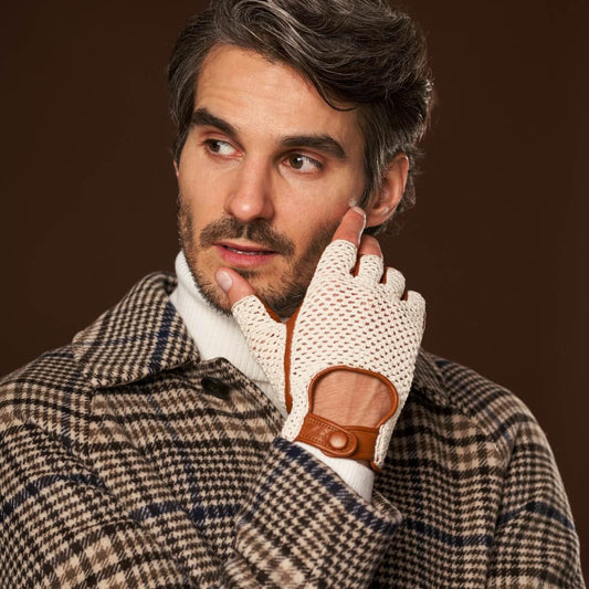 Man wearing a plaid coat and a glove with brown leather patch on a brown background