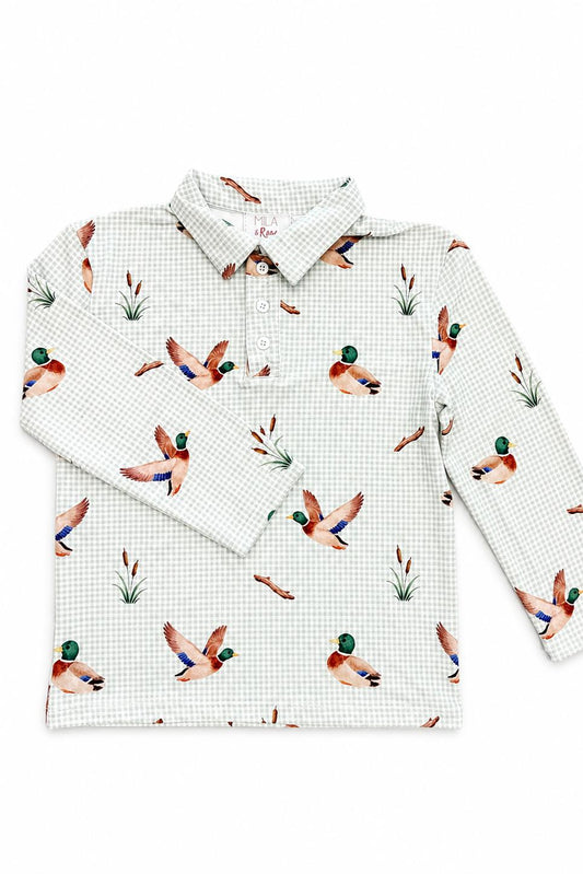 A long-sleeve collared shirt with a white and light gray gingham check pattern and an all-over print of mallards, ducks, and reeds, laid flat on a white background.