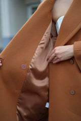 Close-up of a brown coat with a blurred background