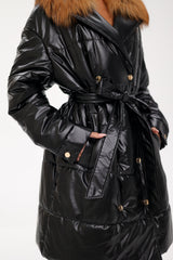 Black puffer coat with fur hood on a white background
