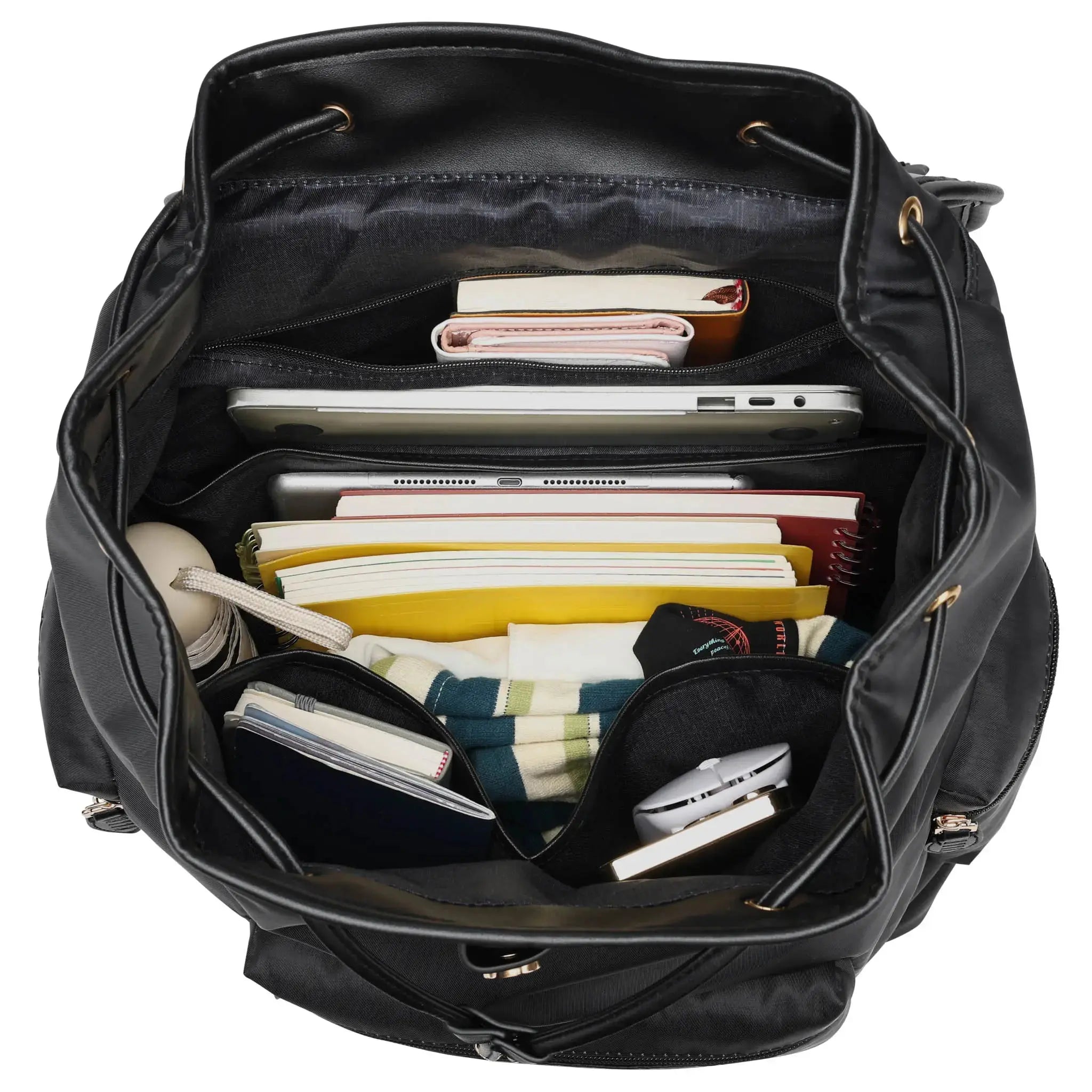 Black backpack with various items inside on a white background