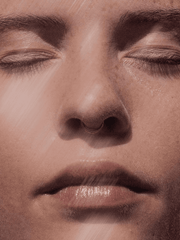 Close-up of a person's face with closed eyes and a neutral expression.