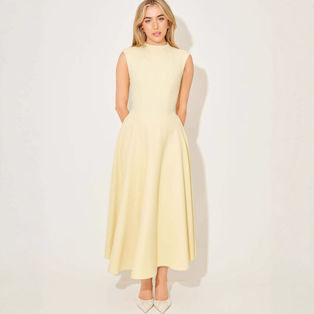 Woman wearing a light yellow dress against a white background