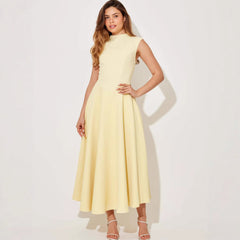 Woman wearing a light yellow dress on a white background