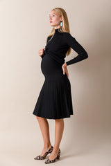 Woman wearing a black dress against a beige background