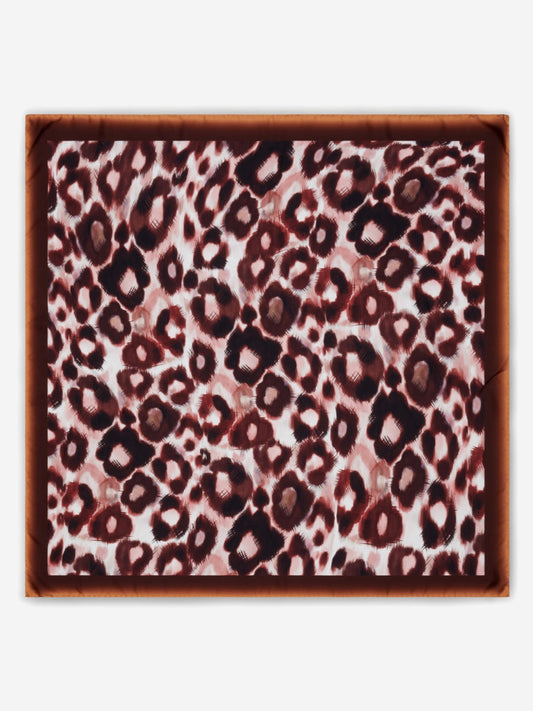 Leopard print silk scarf with a brown border on a white background