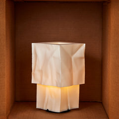 Square lamp with a textured white shade in a brown box