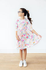 Young girl wearing a floral dress on a white background
