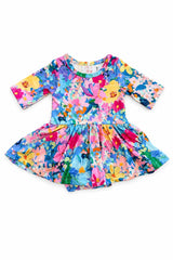 A toddler's long-sleeve dress with a vibrant, multicolor floral and bird print, laid flat on a white background.