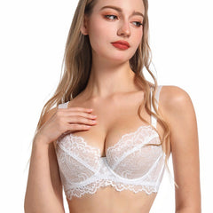 Woman wearing a white lace bra on a white background