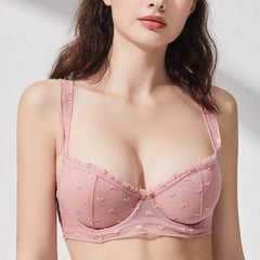 Woman wearing a pink bra with a white background