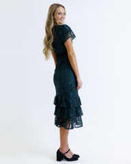 Woman wearing a black lace dress on a white background