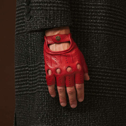 Red leather glove on a person wearing a dark textured coat.