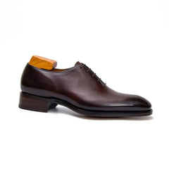 Brown leather dress shoe on a white background