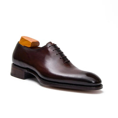 Brown leather dress shoe on a white background