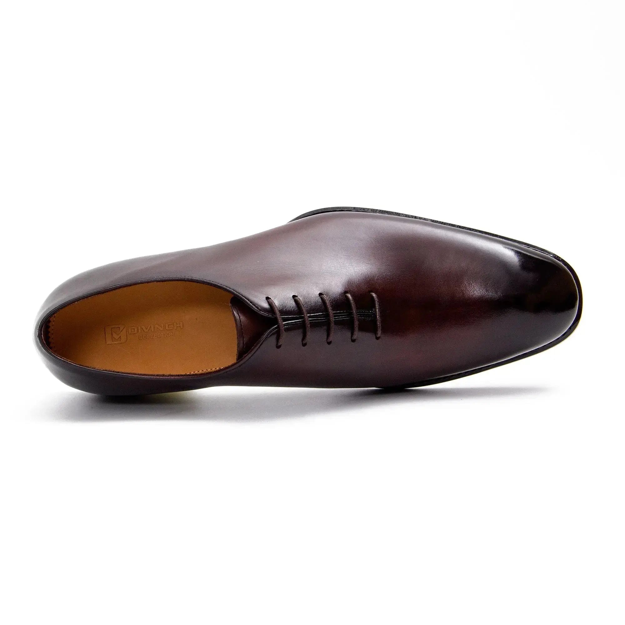 Brown leather dress shoe on a white background