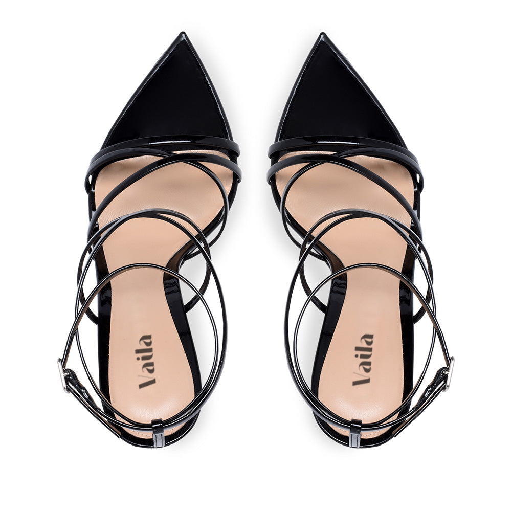 Black strappy high heels on a white background
