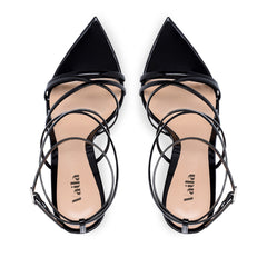 Black strappy high heels on a white background