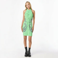 Woman wearing a green dress with a pattern on a white background