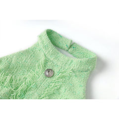 Close-up of a green knitted garment with a button on a white background