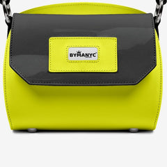 Yellow handbag with black flap and 'BY MANYC' label on a white background