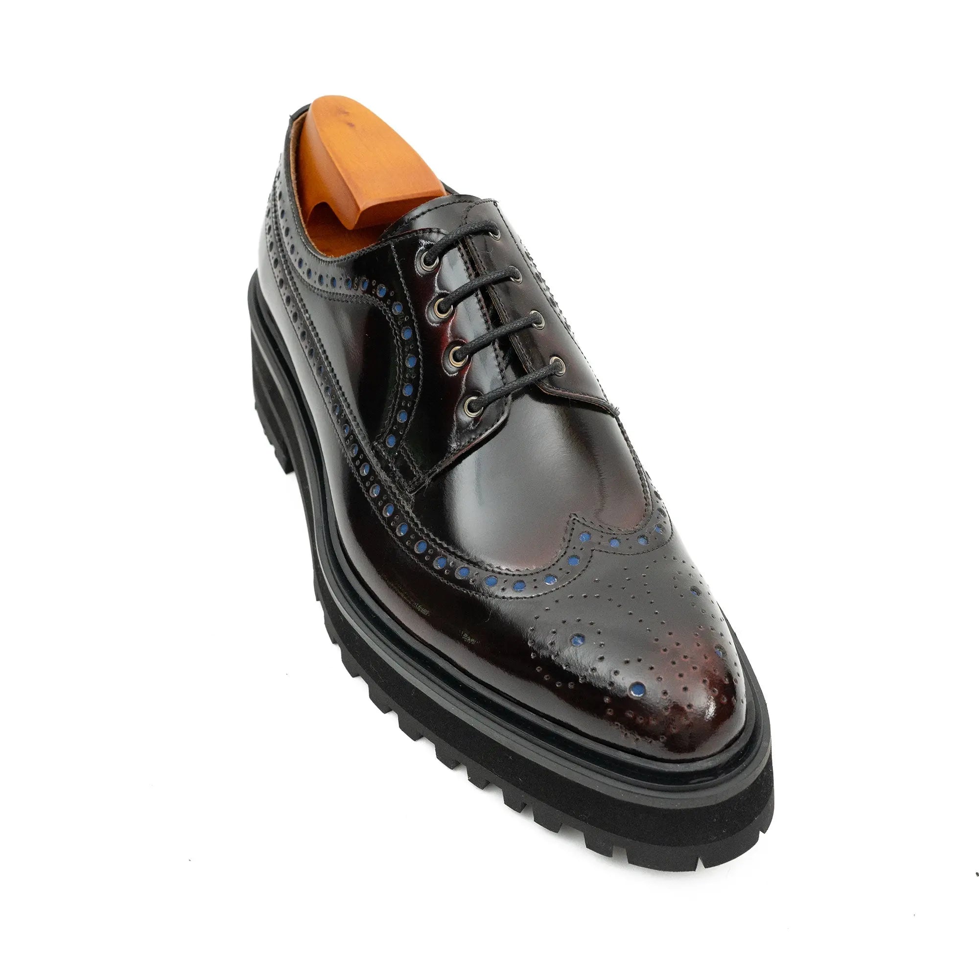 Black leather dress shoe with a thick sole on a white background