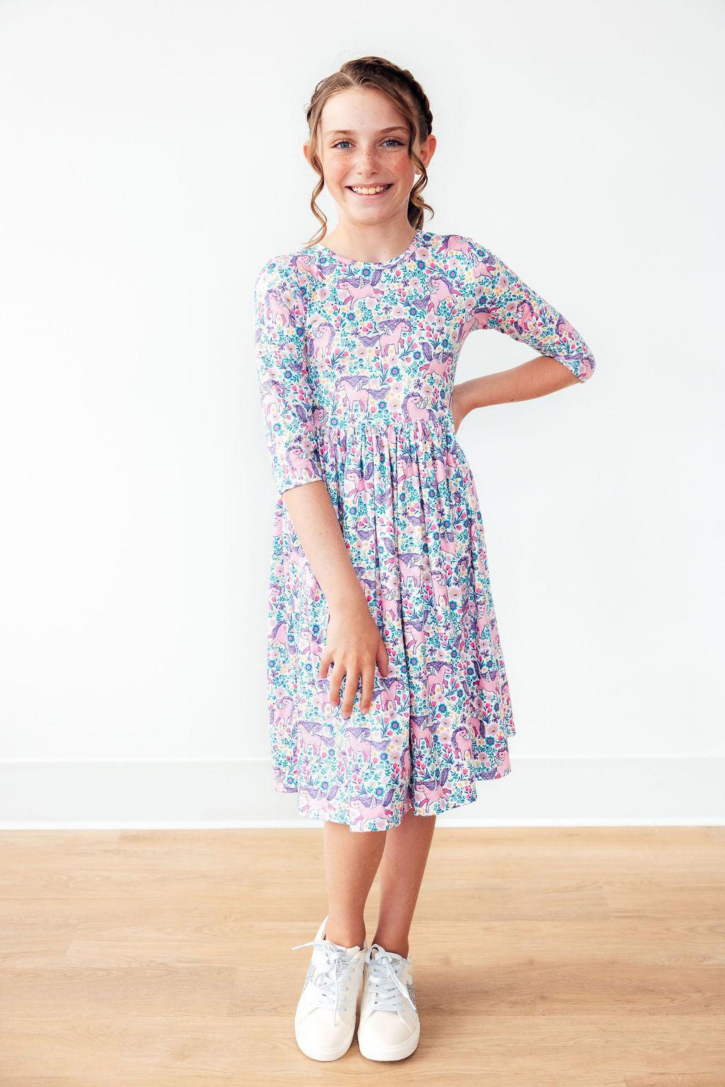 Young girl wearing a floral dress on a white background