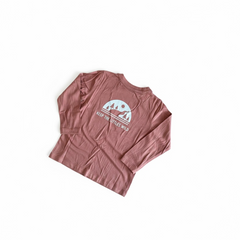 Pink long-sleeve shirt with a graphic design on a white background