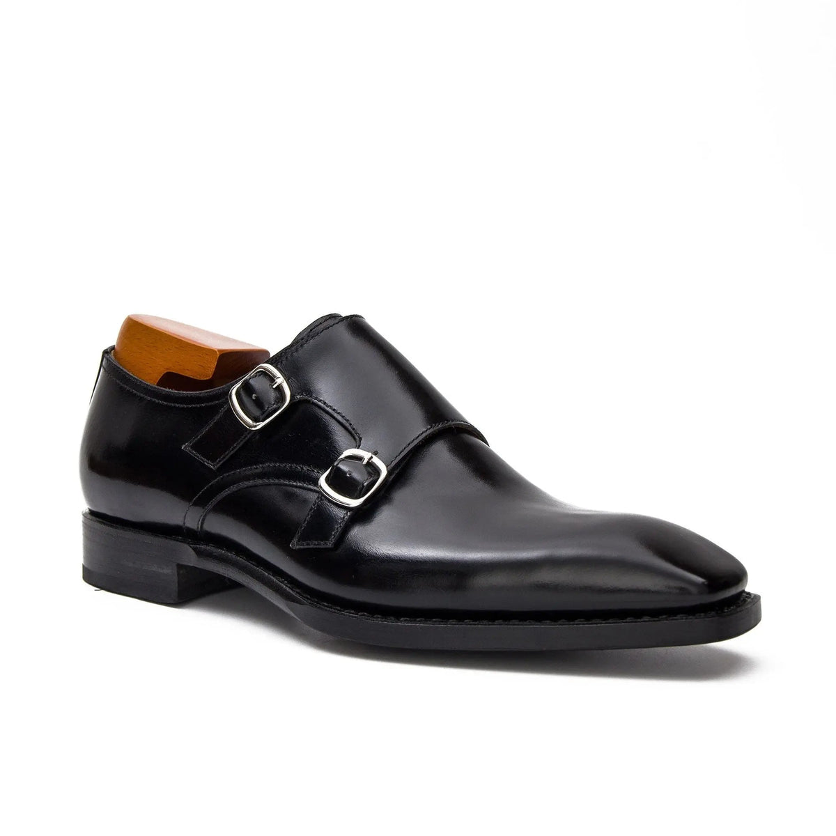 Black leather dress shoe with double buckle on a white background