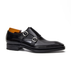 Black leather dress shoe with a single monk strap on a white background