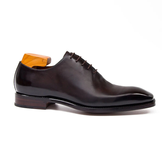 Brown leather dress shoe on a white background