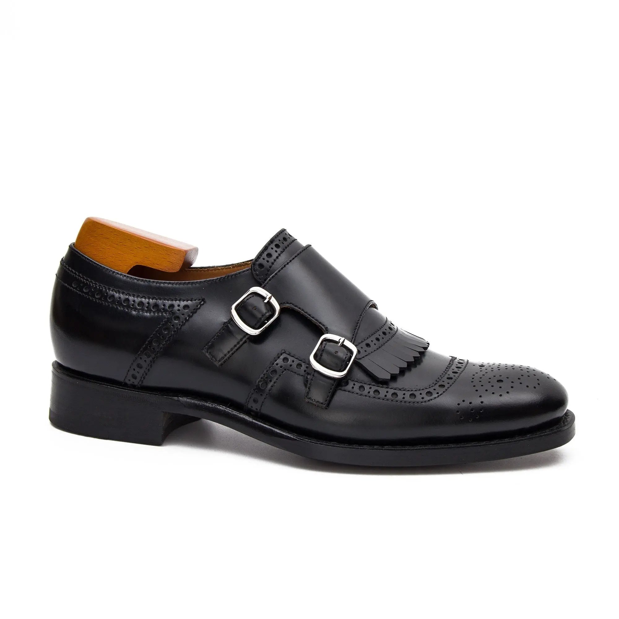 Black leather dress shoe with a wooden insole on a white background