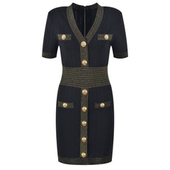 Black dress with gold buttons and trim on a white background